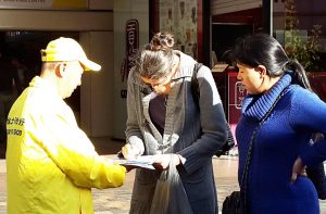 Bernadette (middle) and Nicole (right) sign a petition calling for an end to organ harvesting.