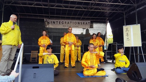 Falun Gong practitioners demonstrate the exercises on-stage.