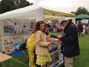 Gemma, a marketing consultant, visits the Falun Dafa booth at East Finchley Festival.