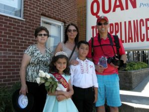 Mr. Carlos Sousa and his family watch the parade.