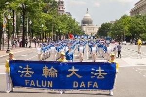 Practitioners' Divine Land Marching Band leads the march.