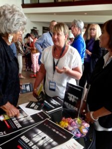 People sign petitions and take informational materials after the film screening.