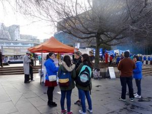 Passersby talking to Falun Gong practitioners