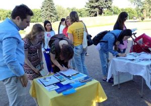 People sign a petition calling for an end to the persecution and organ harvesting.