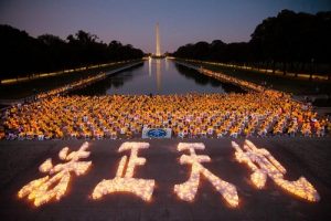 Falun Gong practitioners hold a candlelight vigil in front of Lincoln Memorial on the evening of July 14, 2016.