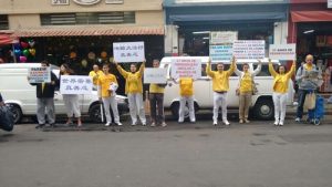 Practitioners hold banners and signs in the Liberdade district in São Paulo, where Chinese businesses have been established.