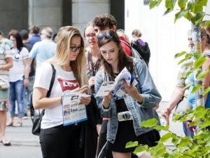 Passerby reading about Falun Gong and the persecution.