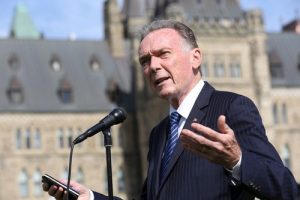 MP Peter Kent gives a speech at the rally in front of Parliament Hill.