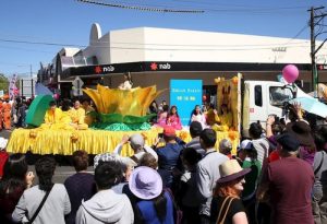 Spectators wave to practitioners on the float.