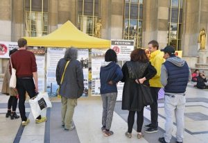 Passersby read posters to learn about Falun Gong and the persecution in China.