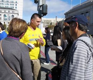 Dorian Fillip talks to tourists in San Francisco about Falun Gong.