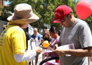 People sign a petition condemning the persecution in China.