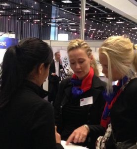 A member of the hosting organization (middle) signs the petition against live organ harvesting.