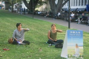 Manuela from Argentina (right) learns the Falun Gong exercises.