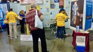 A gentleman reading the and looking at information provided by the Falun Dafa stand.