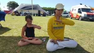 Seven-year-old Hineari does the sitting meditation with practitioners.