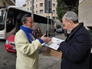 Mr. Domasso listens to a practitioner while reading a flyer.