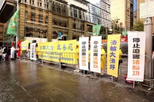 Falun Gong practitioners hold banners during their peaceful protest at Martin Place in Sydney, Australia.