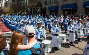 The Tian Guo Marching Band drummers performing in the parade and being enjoyed by many onlookers.