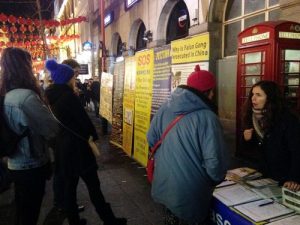 Tilly (on the right) talks to tourists about the persecution in China during the 2017 Chinese New Year.