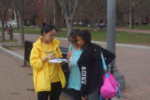 Falun Gong practitioners talk to people passing by about the persecution taking place in China.