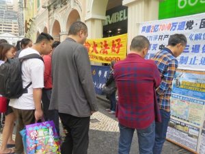 Passerby taking the time to read the banners.