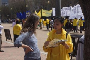 Falun Gong practitioners talk to passersby near the White House about the persecution taking place in China.