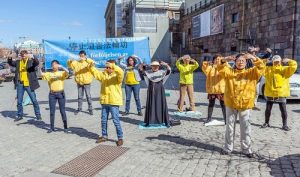 Demonstrating Falun Gong exercises at Mynttorget, outside the parliament building.