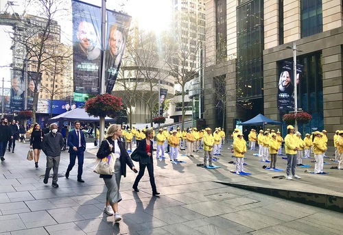 Falun Dafa practitioners perform the exercises before the rally.

