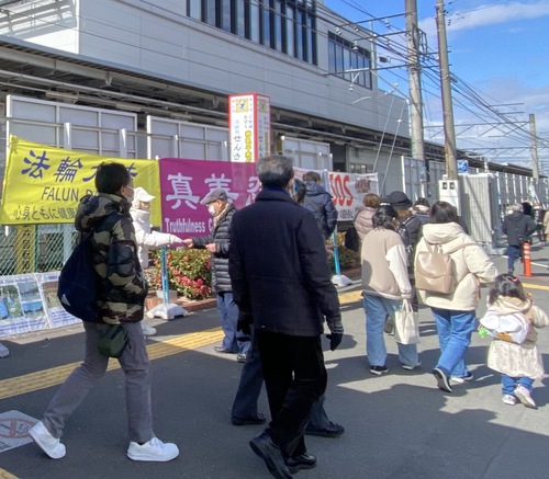 Falun Dafa practitioners distribute fliers to passersby.

