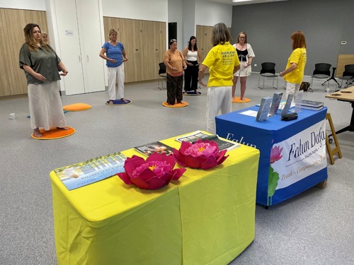 Local residents learn the Falun Dafa exercises.


